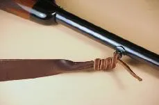 Thong strap threaded through a large sling eye